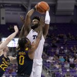 
              West Virginia 's Sean McNeil (22) and Kedrian Johnson (0) defend against a shot by TCU's Mike Miles, top, in the second half of an NCAA college basketball game in Fort Worth, Texas, Monday, Feb. 21, 2022. (AP Photo/Tony Gutierrez)
            