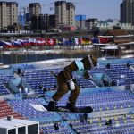 
              Lucile Lefevre of France competes during the women's snowboard big air qualifications of the 2022 Winter Olympics, Monday, Feb. 14, 2022, in Beijing. (AP Photo/Ashley Landis)
            