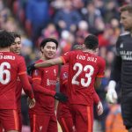
              Liverpool's Takumi Minamino, center, celebrates after scoring his side's second goal during the FA Cup fourth round soccer match between Liverpool and Cardiff City at Anfield stadium in Liverpool, England, Sunday, Feb. 6, 2022. (AP Photo/Jon Super)
            