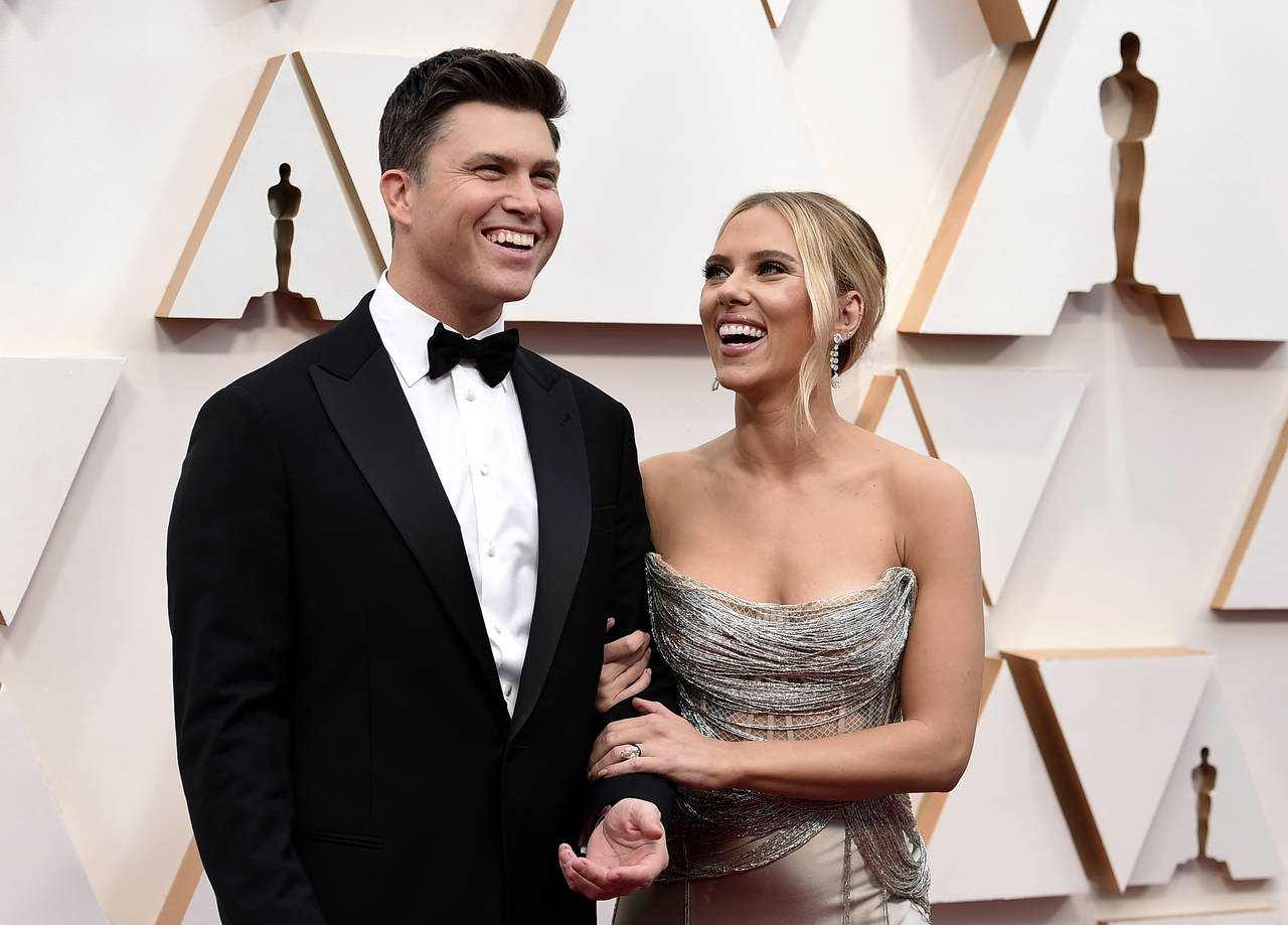 FILE  - Colin Jost, left, and Scarlett Johansson arrive at the Oscars in Los Angeles on Feb. 9, 202...