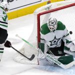 
              Dallas Stars goaltender Jake Oettinger, right, saves a shot by Chicago Blackhawks center Ryan Carpenter, left, during the first period of an NHL hockey game in Chicago, Friday, Feb. 18, 2022. (AP Photo/Nam Y. Huh)
            