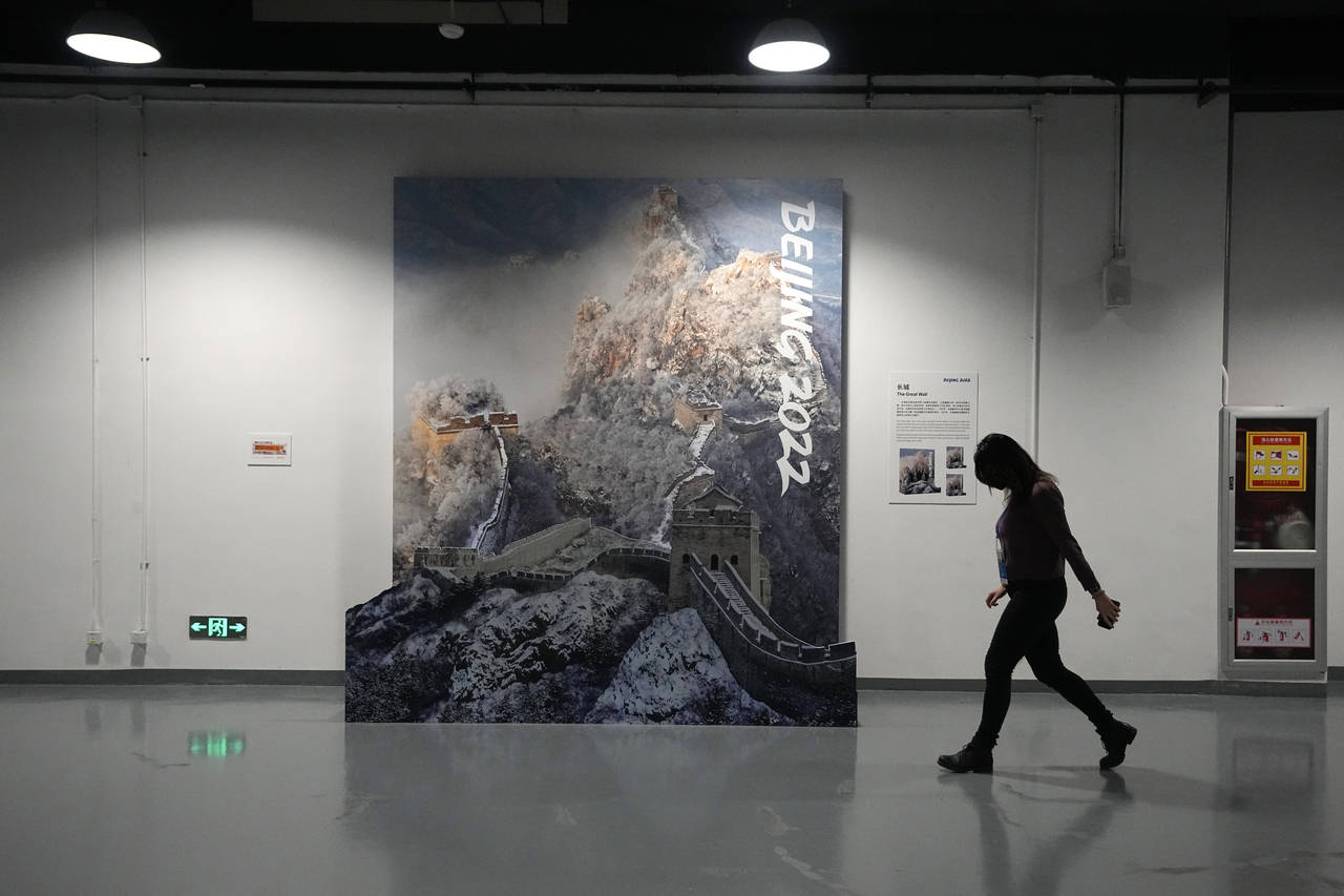 FILE - A person walks past a display of the Great Wall of China in a lower level of the Main Media ...