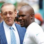 
              FILE -Miami Dolphins head coach Brian Flores talks to Miami Dolphins owner Stephen M. Ross during practice before an NFL football game against the New York Jets, Sunday, Nov. 3, 2019, in Miami Gardens, Fla. Fired Miami Dolphins coach Brian Flores sued the NFL and three of its teams Tuesday, Feb. 1, 2022 saying racist hiring practices by the league have left it racially segregated and managed like a plantation.(AP Photo/Wilfredo Lee, File)
            