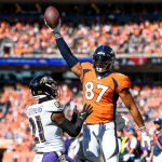 DENVER, CO - OCTOBER 3:  Noah Fant #87 of the Denver Broncos celebrates after a first quarter touchdown catch as Brandon Stephens #21 of the Baltimore Ravens covers the play at Empower Field at Mile High on October 3, 2021 in Denver, Colorado. (Photo by Dustin Bradford/Getty Images)