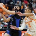 
              Kentucky's Jada Walker (11) drives against Tennessee's Brooklynn Miles (0) in the first half of an NCAA college basketball semifinal round game at the women's Southeastern Conference tournament Saturday, March 5, 2022, in Nashville, Tenn. (AP Photo/Mark Humphrey)
            