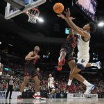 
              Villanova forward Jermaine Samuels, right, shoots over Houston forward J'Wan Roberts during the second half of a college basketball game in the Elite Eight round of the NCAA tournament on Saturday, March 26, 2022, in San Antonio. (AP Photo/Eric Gay)
            
