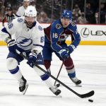 
              Tampa Bay Lightning right wing Nikita Kucherov, front, drives down the ice with the puck as Colorado Avalanche right wing Nicolas Aube-Kubel pursues in the second period of an NHL hockey game Thursday, Feb. 10, 2022, in Denver. (AP Photo/David Zalubowski)
            