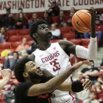 
              Oregon State forward Maurice Calloo, left, and Washington State forward Mouhamed Gueye go after a rebound during the second half of an NCAA college basketball game Thursday, March 3, 2022, in Pullman, Wash. Washington State won 71-67. (AP Photo/Young Kwak)
            