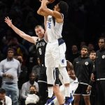 
              Dallas Mavericks guard Spencer Dinwiddie (26) shoots the game-winning three point shot at the buzzer against Brooklyn Nets guard Goran Dragic (9) in the second half of an NBA basketball game, Wednesday, March 16, 2022, in New York. (AP Photo/John Minchillo)
            