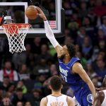 
              Minnesota Timberwolves center Karl-Anthony Towns (32) dunks in front of Phoenix Suns guard Devin Booker and center Deandre Ayton (22) during the first half of an NBA basketball game Wednesday, March 23, 2022, in Minneapolis. (AP Photo/Andy Clayton-King)
            