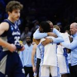 
              North Carolina's Hubert Davis and Caleb Love celebrate after a college basketball game against St. Peter's in the Elite 8 round of the NCAA tournament, Sunday, March 27, 2022, in Philadelphia. (AP Photo/Chris Szagola)
            