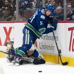 
              St. Louis Blues' Robert Thomas falls to the ice while working against Vancouver Canucks' Tyler Myers (57) for the puck during the third period of an NHL hockey game Wednesday, March 30, 2022, in Vancouver, British Columbia. (Rich Lam/The Canadian Press via AP)
            