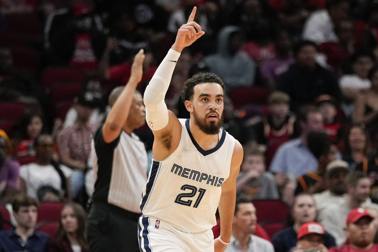 Memphis Grizzlies guard Tyus Jones (21) reacts after making a three point basket during the first h...