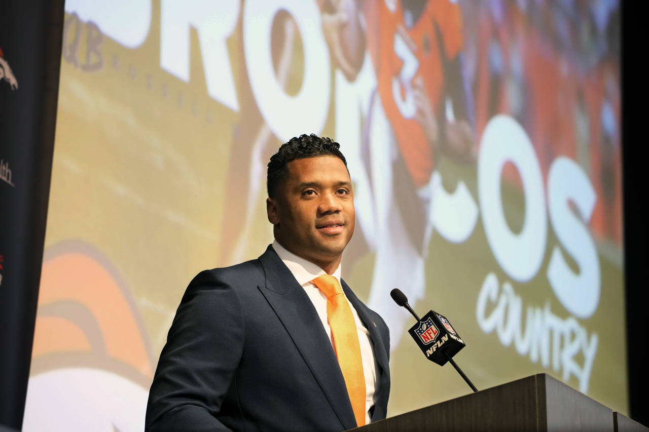 Denver Broncos new starting quarterback Russell Wilson speaks during a news conference Wednesday, M...