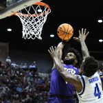 
              TCU guard Mike Miles Jr., left, dunks above Seton Hall forward Tyrese Samuel (4) during the first half of a first-round NCAA college basketball tournament game, Friday, March 18, 2022, in San Diego. (AP Photo/Denis Poroy)
            