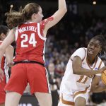 
              Texas guard Joanne Allen-Taylor (11) passes around Ohio State guard Taylor Mikesell (24) during the first half of a college basketball game in the Sweet 16 round of the NCAA tournament, Friday, March 25, 2022, in Spokane, Wash. (AP Photo/Young Kwak)
            