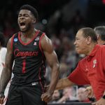 
              Houston guard Jamal Shead celebrates after scoring with head coach Kelvin Sampson during the first half of a college basketball game against Arizona in the Sweet 16 round of the NCAA tournament on Thursday, March 24, 2022, in San Antonio. (AP Photo/David J. Phillip)
            
