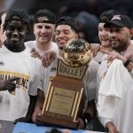 
              Members of Loyola of Chicago celebrate after defeating Drake 64-58 in an NCAA college basketball game to win the Missouri Valley Conference tournament championship Sunday, March 6, 2022, in St. Louis. (AP Photo/Jeff Roberson)
            