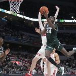 
              Michigan State's Gabe Brown (44) shoots against Wisconsin's Steven Crowl during the second half of an NCAA college basketball game at the Big Ten Conference tournament, Friday, March 11, 2022, in Indianapolis. (AP Photo/Darron Cummings)
            