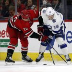 
              Carolina Hurricanes' Ethan Bear (25) battles with Tampa Bay Lightning's Ondrej Palat (18) during the second period of an NHL hockey game in Raleigh, N.C., Tuesday, March 22, 2022. (AP Photo/Karl B DeBlaker)
            