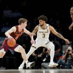 
              Virginia Tech's Sean Pedulla, left, drives against Notre Dame's Prentiss Hubb, center, in the second half of an NCAA college basketball game during quarterfinals of the Atlantic Coast Conference men's tournament, Thursday, March 10, 2022, in New York. (AP Photo/John Minchillo)
            