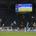 
              Ukraine's flag is displayed on a giant screen prior to the start of the Serie A soccer match between Lazio and Napoli at Rome's Olympic stadium, Sunday, Feb. 27, 2022. (AP Photo/Gregorio Borgia)
            
