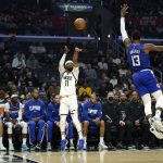 
              Utah Jazz guard Mike Conley, center, shoots as Los Angeles Clippers guard Paul George defends during the first half of an NBA basketball game Tuesday, March 29, 2022, in Los Angeles. (AP Photo/Mark J. Terrill)
            