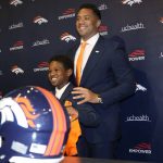 
              Denver Broncos new starting quarterback Russell Wilson, right, stands with his son, Future, after a news conference Wednesday, March 16, 2022, at the team's headquarters in Englewood, Colo. (AP Photo/David Zalubowski)
            