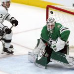 
              The puck deflects off of Dallas Stars goaltender Jake Oettinger (29) as Los Angeles Kings defenseman Matt Roy (3) closes in during the first period of an NHL hockey game in Dallas, Wednesday, March 2, 2022. (AP Photo/LM Otero)
            