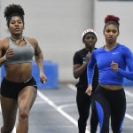 
              Kentucky track & field athlete Masai Russell, right, runs during practice at Nutter Field House in Lexington, Ky., Friday, Feb. 18, 2022. Russell is among a cohort of NCAA women's athletes who are making a name for themselves on social media. (AP Photo/Timothy D. Easley)
            