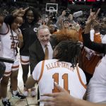 
              Texas head coach Vic Schaefer reacts with guard Joanne Allen-Taylor (11) as he huddles with his team after a college basketball game against Ohio State in the Sweet 16 round of the NCAA tournament, Friday, March 25, 2022, in Spokane, Wash. Texas won 66-63. (AP Photo/Ted S. Warren)
            