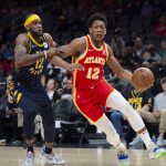 
              Atlanta Hawks forward De'Andre Hunter, right, drives past Indiana Pacers forward Oshae Brissett, left, during the first half of an NBA basketball game Sunday, March 13, 2022, in Atlanta. (AP Photo/Hakim Wright Sr.)
            