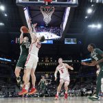 
              Michigan State's Joey Hauser (10) shoots against Wisconsin's Chris Vogt (33) during the first half of an NCAA college basketball game at the Big Ten Conference tournament, Friday, March 11, 2022, in Indianapolis. (AP Photo/Darron Cummings)
            