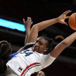 
              Dayton center Tenin Magassa (34) grabs a rebound over DePaul forward Aneesah Morrow, left, during the first half of a First Four game in the NCAA women's college basketball tournament, Wednesday, March 16, 2022, in Ames, Iowa. (AP Photo/Charlie Neibergall)
            