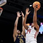 
              Notre Dame's Paul Atkinson Jr., left, defends as Rutgers' Ron Harper Jr. drives to the basket during the first half of a First Four game in the NCAA men's college basketball tournament Wednesday, March 16, 2022, in Dayton, Ohio. (AP Photo/Aaron Doster)
            
