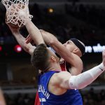 
              Chicago Bulls guard Alex Caruso, right, drives to the basket against Los Angeles Clippers center Isaiah Hartenstein during the first half of an NBA basketball game in Chicago, Thursday, March 31, 2022. (AP Photo/Nam Y. Huh)
            