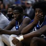
              St. Peter's Clarence Rupert, right, and Fousseyni Drame watch from the bench during the second half of a college basketball game against North Carolina in the Elite 8 round of the NCAA tournament, Sunday, March 27, 2022, in Philadelphia. (AP Photo/Chris Szagola)
            