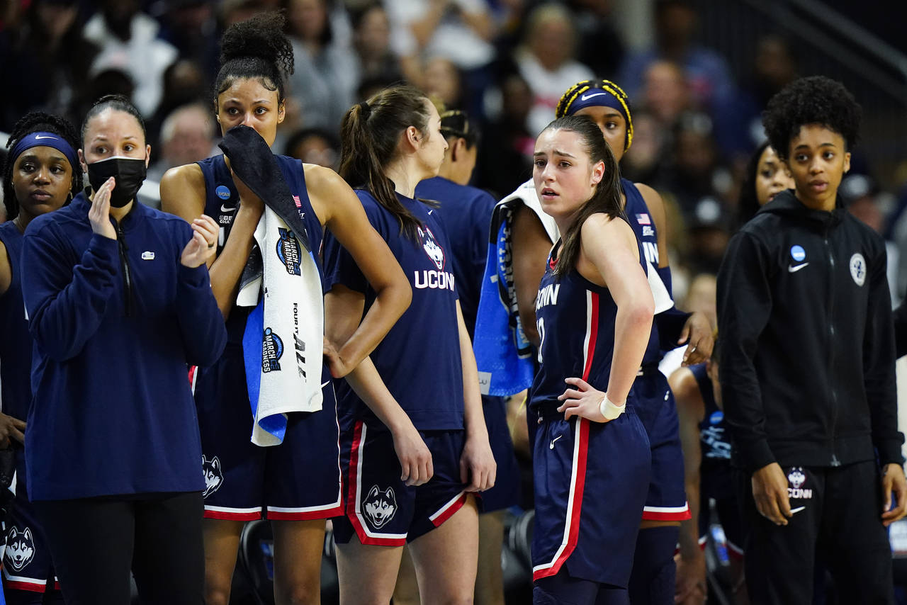 Connecticut players watch as teammate Dorka Juhasz (not pictured) is helped off the court after an ...