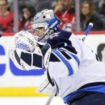 
              Winnipeg Jets goaltender Eric Comrie (1) stops a shot against the New Jersey Devils during the first period of an NHL hockey game Thursday, March 10, 2022, in Newark, N.J. (AP Photo/Eduardo Munoz Alvarez)
            