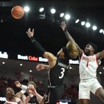 
              Cincinnati guard Mike Saunders Jr. (3) shoots next to Houston guard Jamal Shead (1) during the first half of an NCAA college basketball game Tuesday, March 1, 2022, in Houston. (AP Photo/Justin Rex)
            