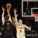 
              Cleveland Cavaliers forward Kevin Love (0) shoots over Atlanta Hawks guard Kevin Huerter (3) during the first half of an NBA basketball game Thursday, March 31, 2022, in Atlanta. (AP Photo/Hakim Wright Sr.)
            