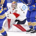 
              Florida Panthers goaltender Spencer Knight (30) looks for the puck in traffic during the first period of an NHL hockey game against the Buffalo Sabres, Monday, March 7, 2022, in Buffalo, N.Y. (AP Photo/Jeffrey T. Barnes)
            