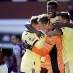
              Arsenal goalkeeper Bernd Leno, center, celebrates with teammates Thomas Partey, Ben White, right, and Rob Holding, left, after making a save in the closing stages of the English Premier League soccer match between Aston Villa and Arsenal at Villa Park, Birmingham, England, Saturday, March 19, 2022. (Nick Potts/PA via AP)
            