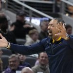 
              Michigan head coach Juwan Howard encourages fans during the second half of a college basketball game against Tennessee in the second round of the NCAA tournament, Saturday, March 19, 2022, in Indianapolis. (AP Photo/Darron Cummings)
            