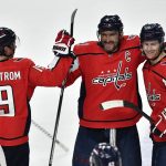 
              Washington Capitals left wing Alex Ovechkin, center, celebrates with center Nicklas Backstrom, left, and defenseman Nick Jensen after scoring the winning goal against the Buffalo Sabres during the shootout of an NHL hockey game in Buffalo, N.Y., Friday, March 25, 2022. (AP Photo/Adrian Kraus)
            