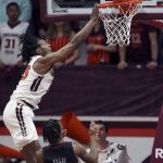 
              Virginia Tech's Justyn Mutts (25) scores over Louisville's El Ellis (3) during the first half of an NCAA college basketball game Tuesday, March 1, 2022, in Blacksburg, Va. (Matt Gentry/The Roanoke Times via AP)
            