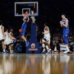 
              Creighton's Ryan Kalkbrenner (11) dunks in front of Villanova's Justin Moore, third from front left, Collin Gillespie (2) and Caleb Daniels (14) during the first half of an NCAA college basketball game in the final of the Big East conference tournament Saturday, March 12, 2022, in New York. (AP Photo/Frank Franklin II)
            