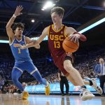 
              Southern California guard Drew Peterson, right, drives past UCLA guard Jules Bernard during the first half of an NCAA college basketball game Saturday, March 5, 2022, in Los Angeles. (AP Photo/Mark J. Terrill)
            