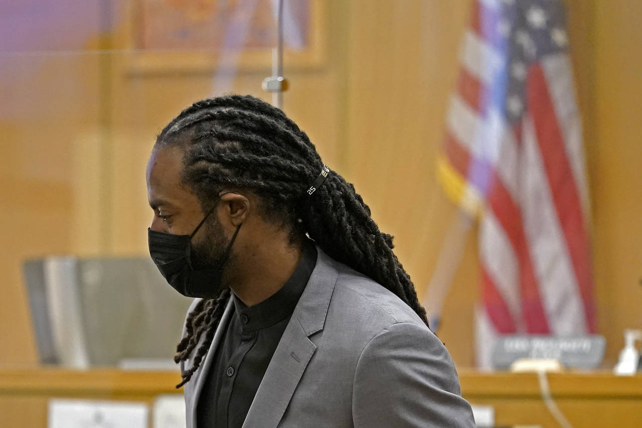 FILE - Richard Sherman stands up to leave a King County District Court hearing, Friday, July 16, 20...