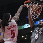 
              Brooklyn Nets forward James Johnson (16) dunks the ball past Toronto Raptors forward Precious Achiuwa (5) during the second half of an NBA basketball game in Toronto on Tuesday, March 1, 2022. (Nathan Denette/The Canadian Press via AP)
            